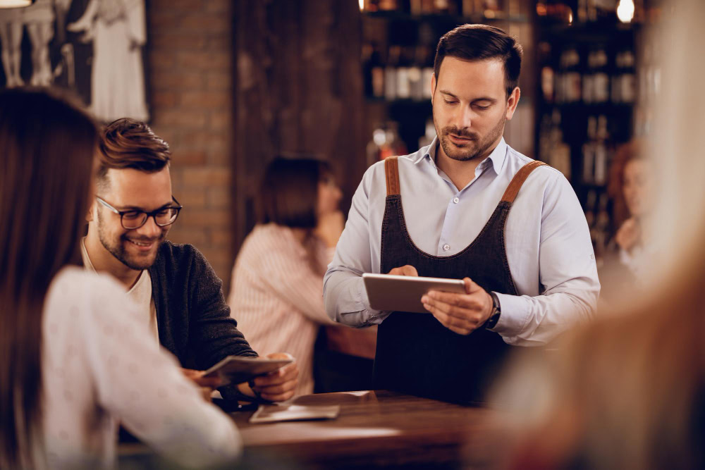 waiter using a mobile pos to take orders